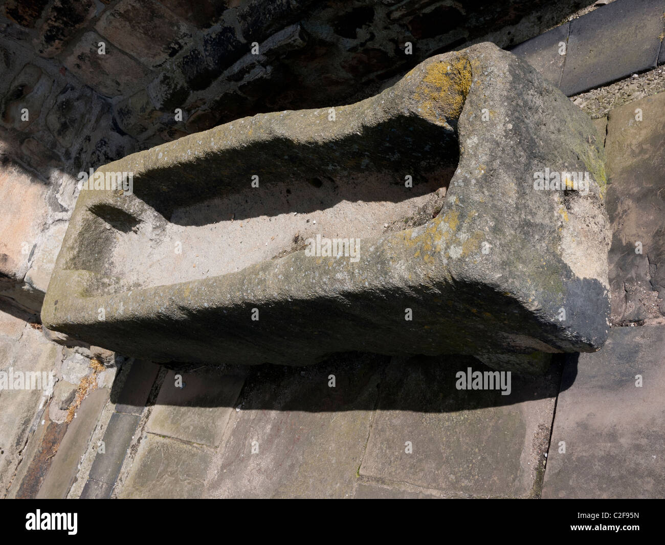 Medieval stone coffin outside St Mary`s Church, Whalley, Clitheroe, Lancashire, England, UK. Stock Photo